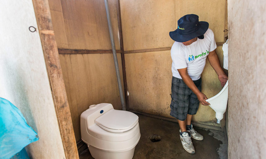 man installs toilet